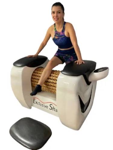 User sitting on Roll Magic Body Roll Machine while enjoying a massage