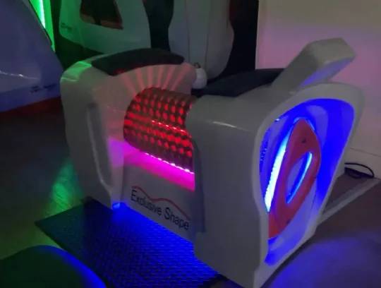 Roll Magic Body Roll Machine with colored LED lights glowing during use