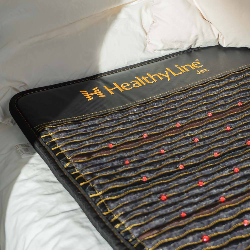 Jet Mat on Bed – A close-up of the HealthyLine Jet mat placed on a white bed