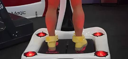 Person using Magic Vib platform with ankle straps for enhanced vibration therapy