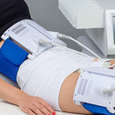 Slim 4 in use during a non-invasive body contouring treatment with laser applicators positioned on the abdomen.