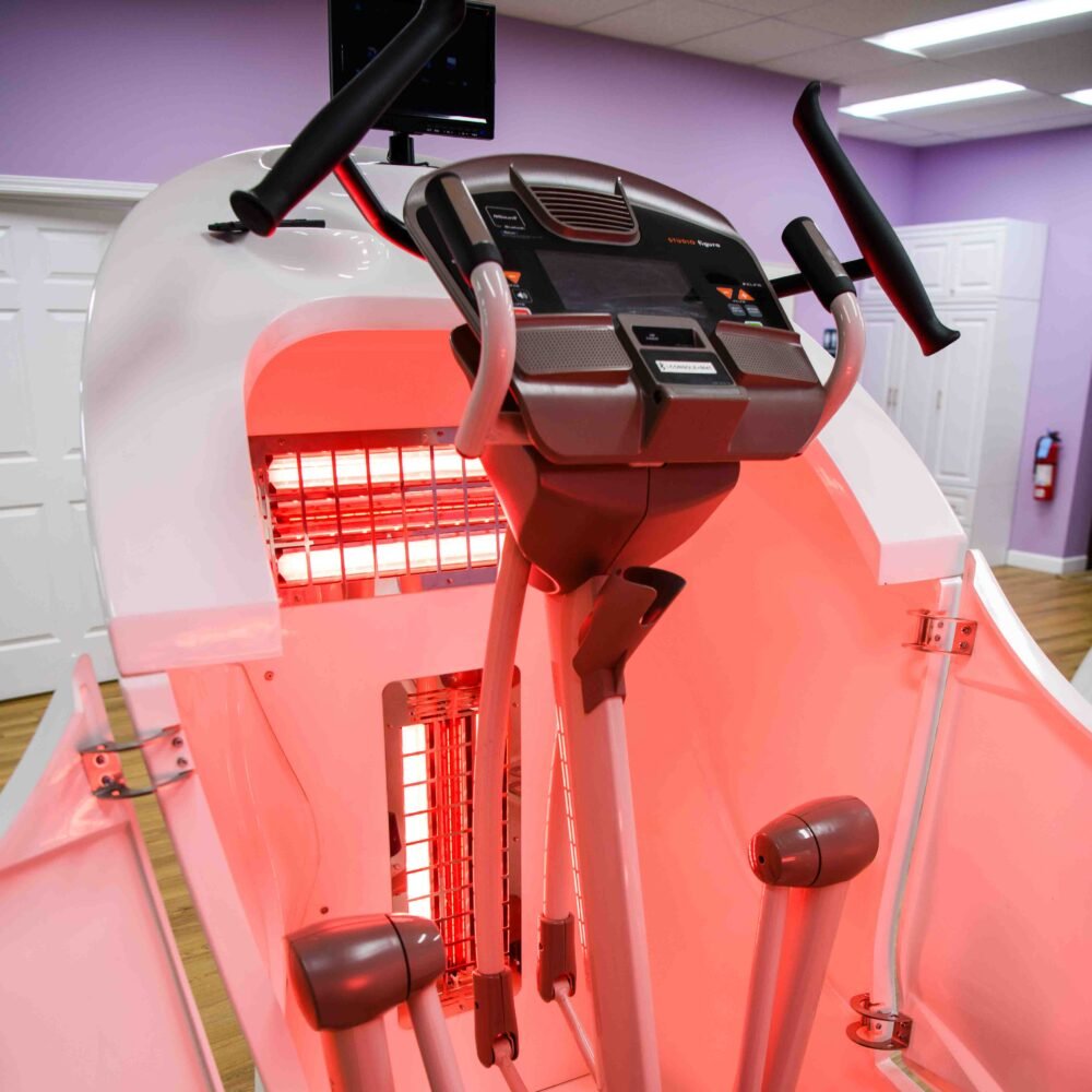 Interior view of the Swan Infra Shaper Classic showcasing the elliptical trainer, infrared light panels, and user-friendly control console.