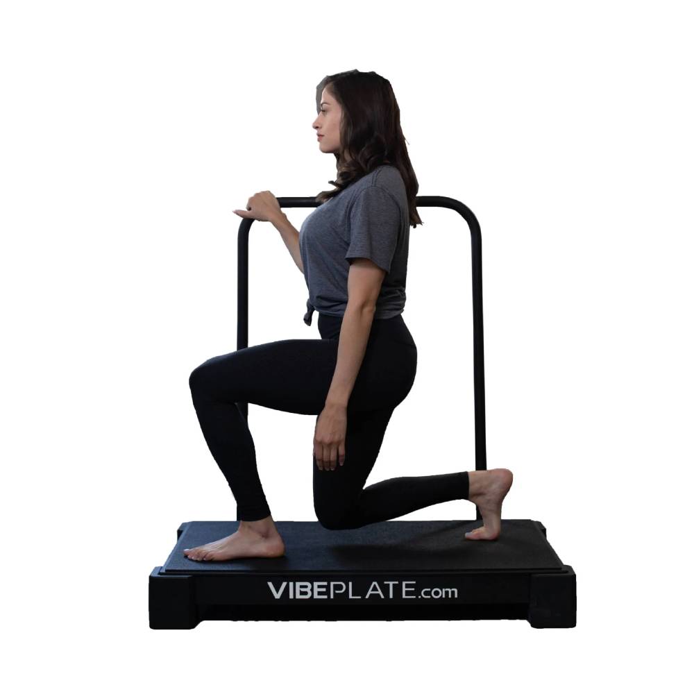 User performing a supported lunge exercise with the optional VibePlate Balance Bar