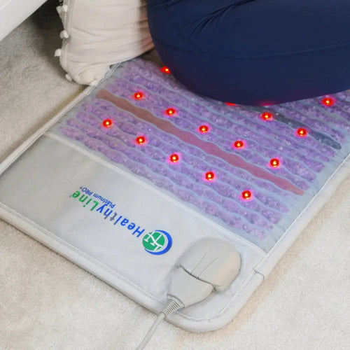 HealthyLine Platinum 32 x 20 in. PEMF mat in use with its red photon lights glowing