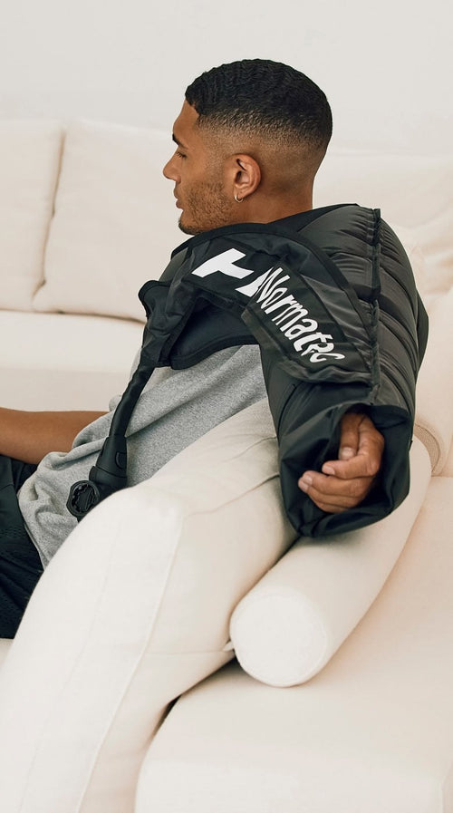 Hyperice Normatec 3 Full Body worn during use.
