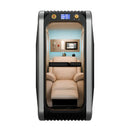 Interior of a hyperbaric oxygen chamber showing a plush cream-colored leather recliner, a touchscreen control interface, and an emergency communication handset.