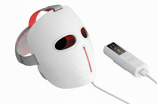 White facial mask with red lights and a remote control on a white background.