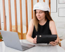 Woman wearing Neuronic NR-1070 helmet while working on laptop