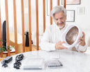 Man examining Neuronic NR-1070 helmet with accessories on table