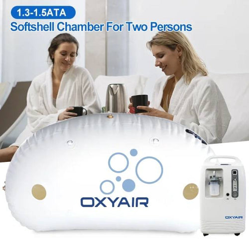 Two women in robes with Oxyair 1.5 ATA chamber and oxygen machine