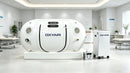 Oxyair RZT02 soft hyperbaric chamber shown in a clinic treatment room with its concentrator