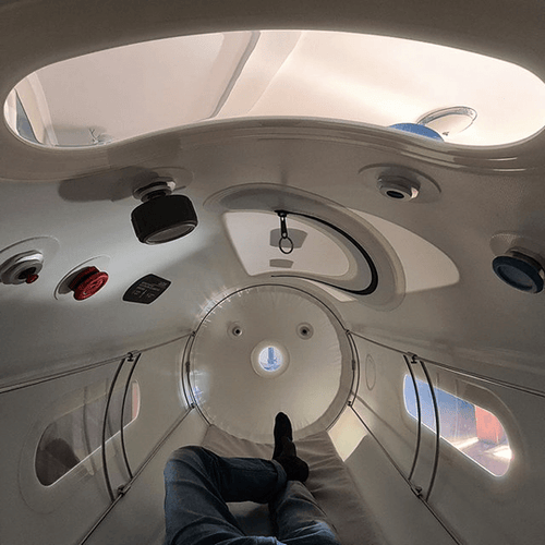 Inside Oxyrevo chamber with person lying.