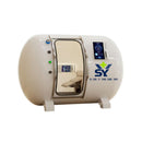 White YCMY-G02D luxury hard-shell hyperbaric oxygen chamber with piano finish, showing the 15.6-inch external control panel and medical-grade leather reclining sofa inside.
